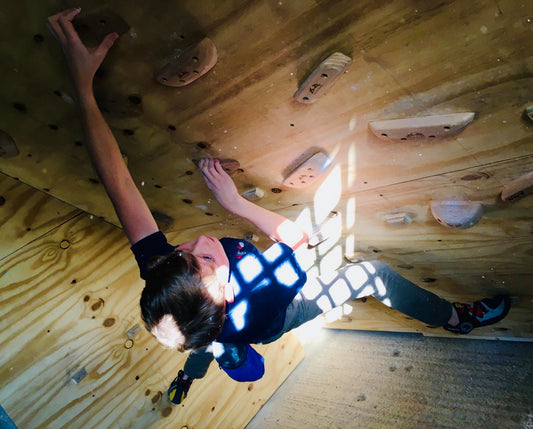 A boy climbing on a wall
